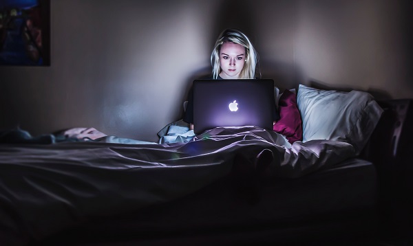 woman in the bed using laptop